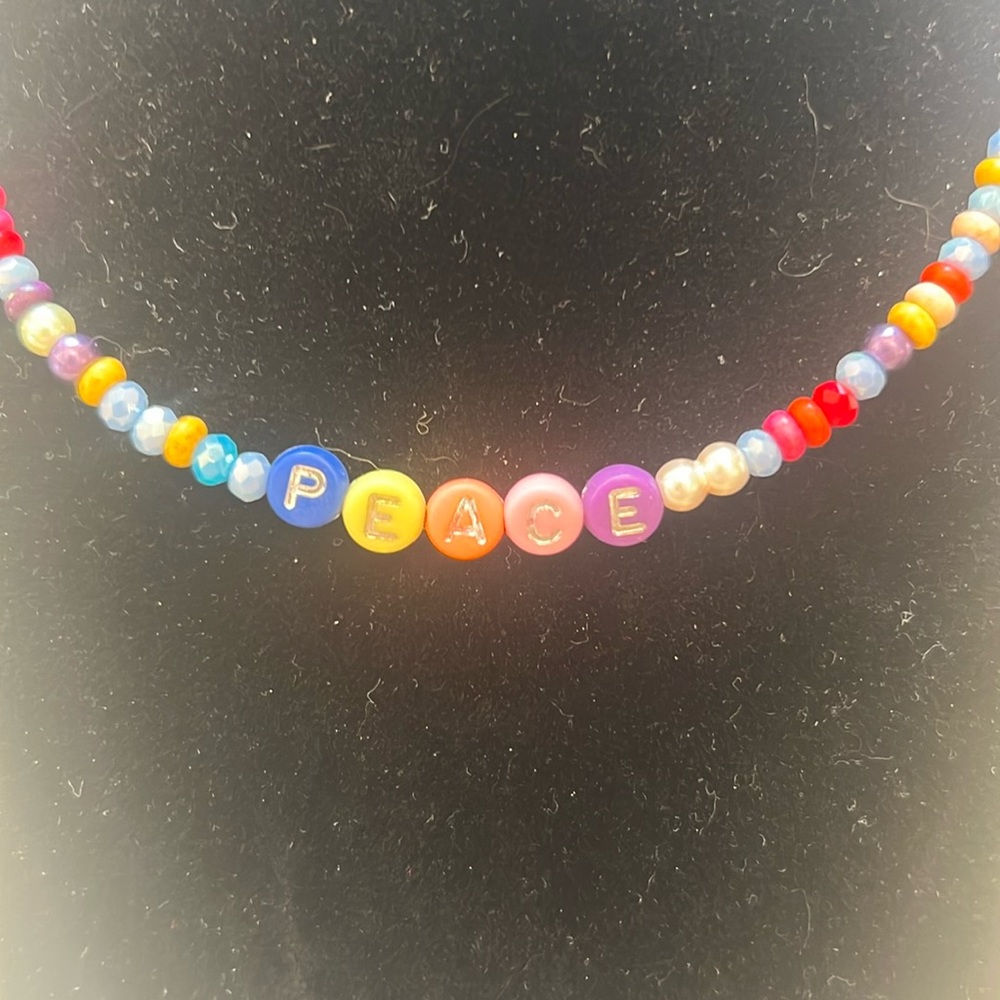 Handmade 16” faux pearl, rainbow colored and PEACE beaded necklace.